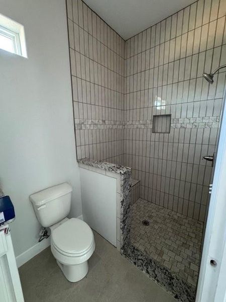Full bath featuring walk in shower and toilet