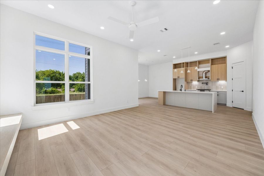 Walls of windows, soaring ceilings, and seamless indoor outdoor connections create a bright gathering space designed for entertaining.