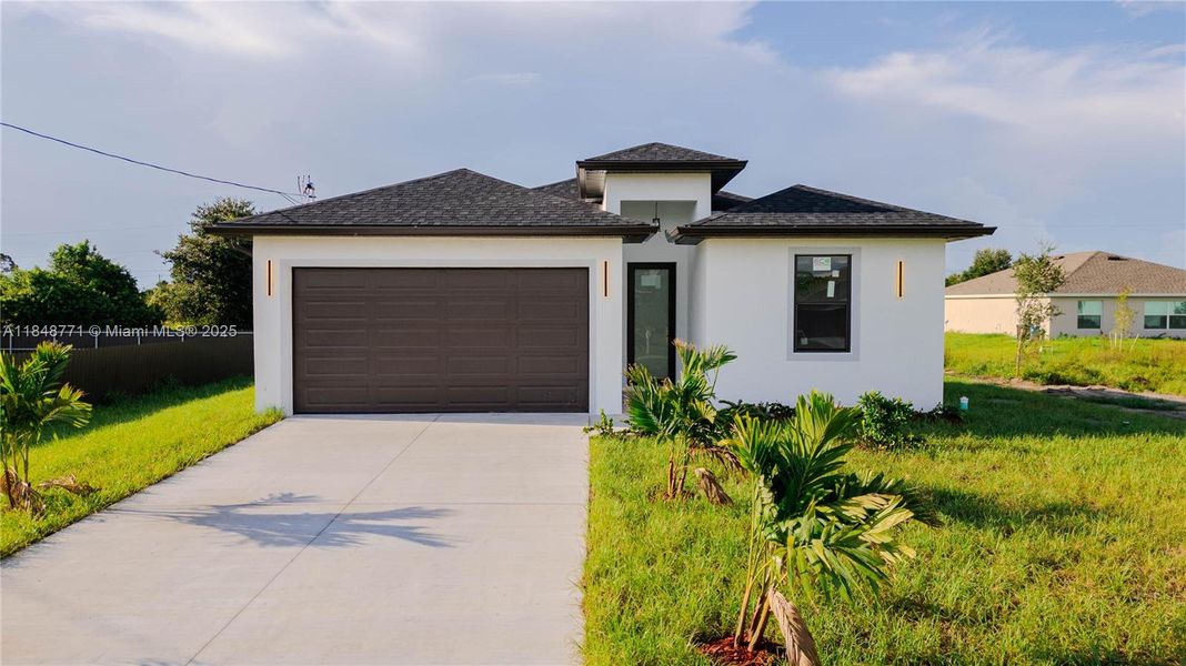 Front exterior of a new home in , Lehigh Acres, FL, highlighting curb appeal (Image 13). Front exterior of a new home in , Lehigh Acres, FL, highlighting curb appeal (Image 13).