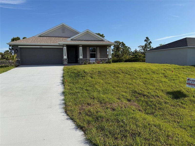 Front exterior of a new home in , Port Charlotte, FL, highlighting curb appeal (Image 1). Front exterior of a new home in , Port Charlotte, FL, highlighting curb appeal (Image 1).