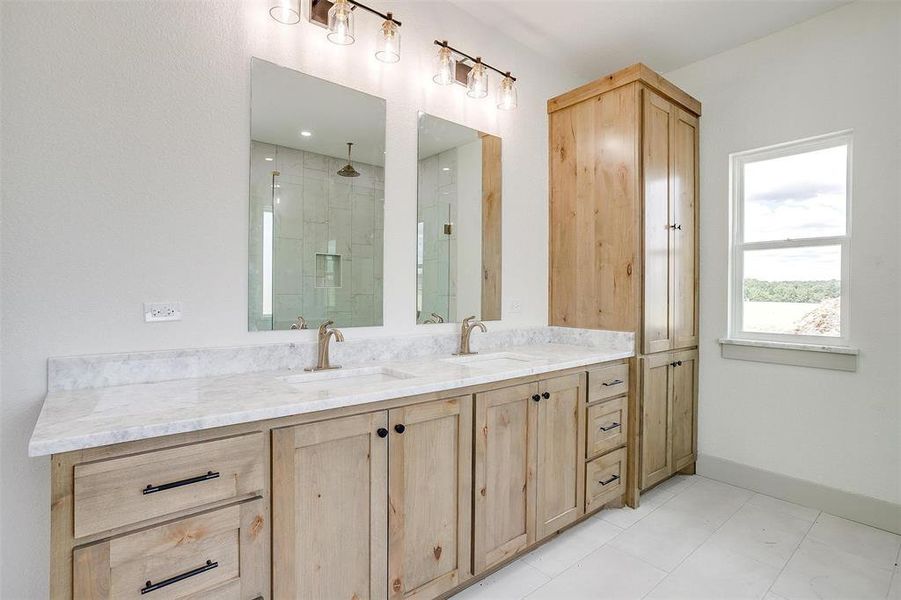 Bathroom featuring vanity, a shower with shower door, and tile patterned floors