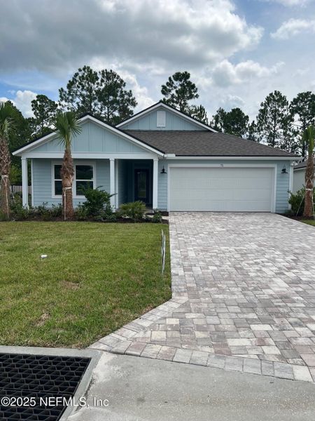 Front exterior of a new home in American Village, Palm Coast, FL, highlighting curb appeal (Image 1). Front exterior of a new home in American Village, Palm Coast, FL, highlighting curb appeal (Image 1).