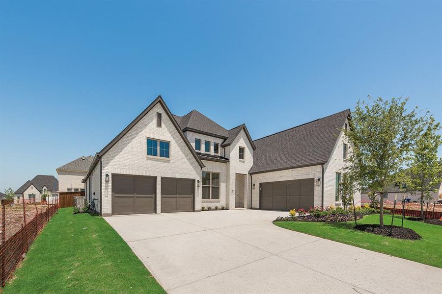 Modern farmhouse with brick siding, driveway, a shingled roof, and a garage Modern farmhouse with brick siding, driveway, a shingled roof, and a garage