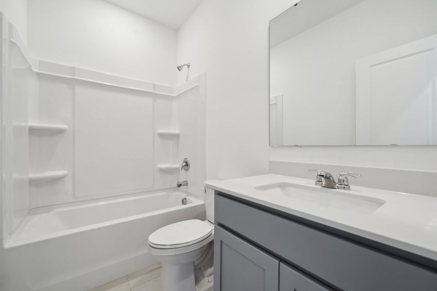 A bathroom with a sink toilet and bathtub. A bathroom with a sink toilet and bathtub.