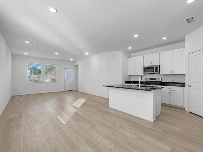 Open floor plan that includes dining area, kitchen, and living room. Open floor plan that includes dining area, kitchen, and living room.