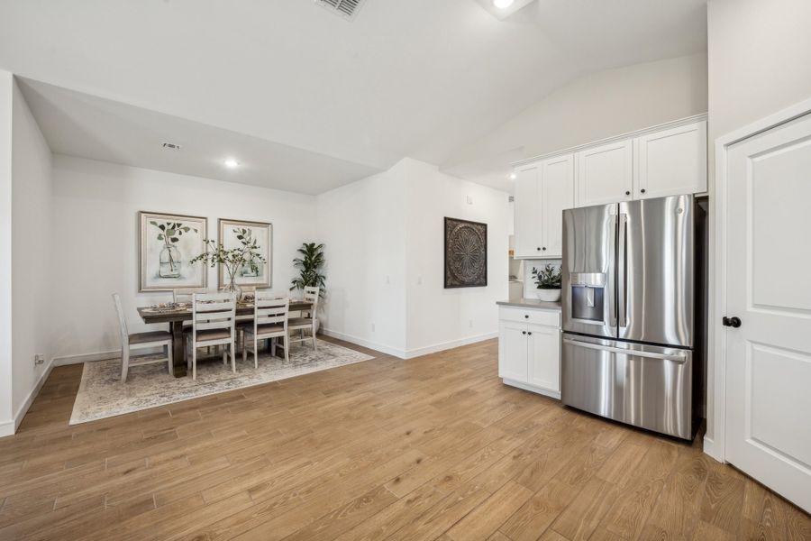 Kitchen with stainless steel appliances and wood-look tile