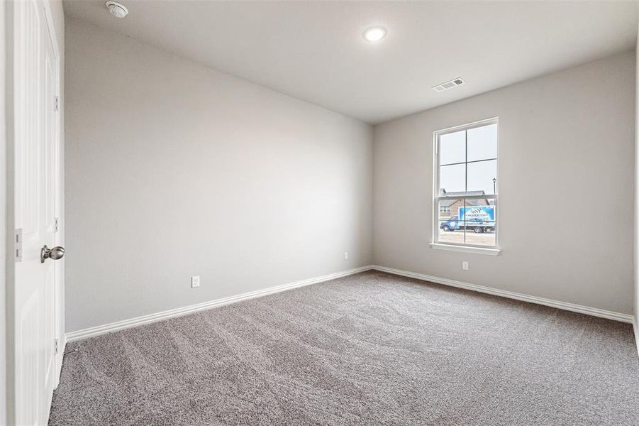 Carpeted empty room featuring baseboards and recessed lighting