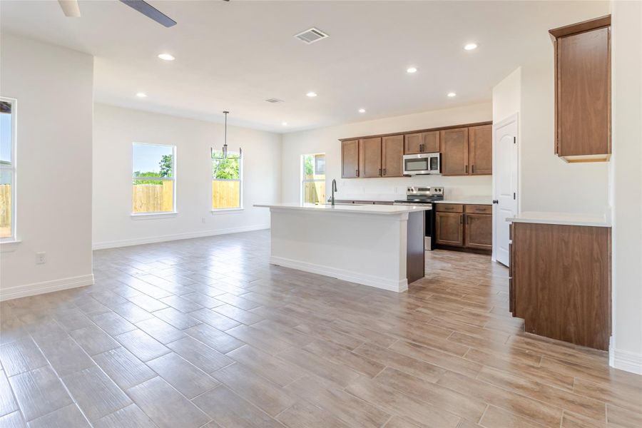 The kitchen stays within talking distance of both the living and dining areas, with the island right at the center of it all. The kitchen stays within talking distance of both the living and dining areas, with the island right at the center of it all.