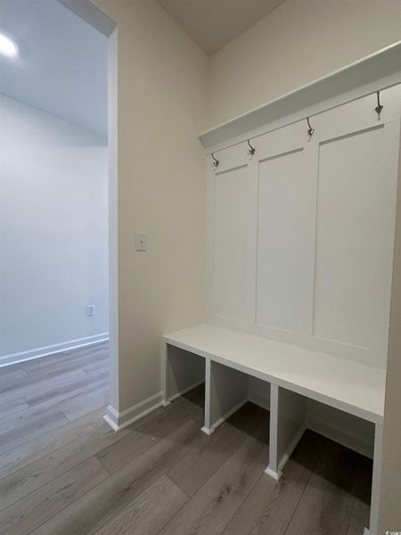 Mudroom with light wood-type flooring and baseboards