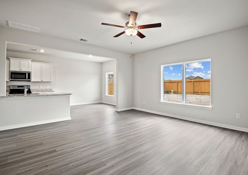 A spacious family room and adjoining kitchen and dining room