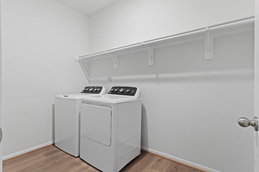The utility room provides function and organization, complete with washer and dryer connections and built-in shelving. A clean, well-lit space that keeps laundry tasks simple and efficient.  Brand new energy saving washer and dryer included!