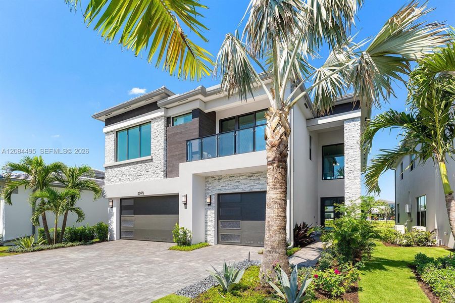 Front exterior of a new home in Lotus Edge, Boca Raton, FL, highlighting curb appeal (Image 22). Front exterior of a new home in Lotus Edge, Boca Raton, FL, highlighting curb appeal (Image 22).
