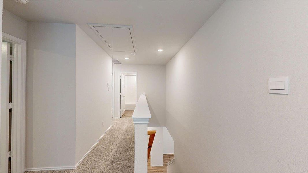 Corridor featuring carpet flooring, an upstairs landing, attic access, and recessed lighting Corridor featuring carpet flooring, an upstairs landing, attic access, and recessed lighting
