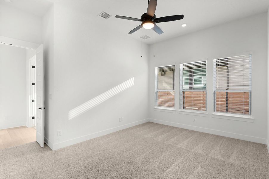 Spare room featuring light carpet, ceiling fan, and recessed lighting