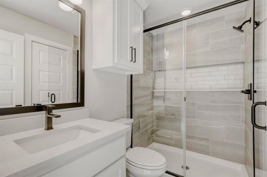 Full bath with a stall shower and vanity