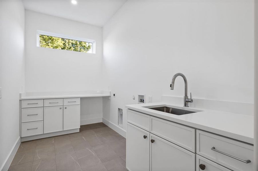 Laundry room with cabinets, hookup for a washing machine, electric dryer hookup, and sink