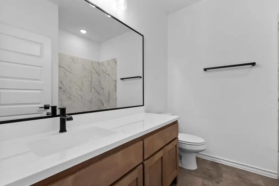 Full upstairs bathroom and contemporary black fixtures.