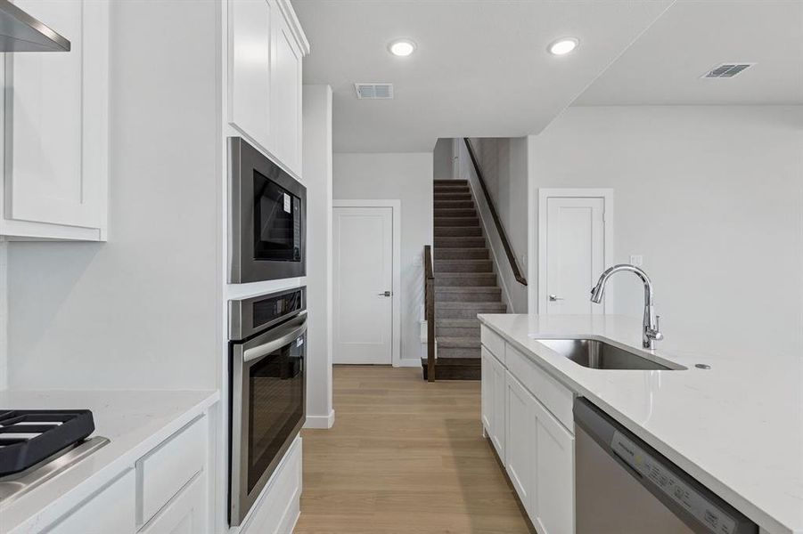 Kitchen in the Stanley II home plan by Trophy Signature Homes – REPRESENTATIVE PHOTO