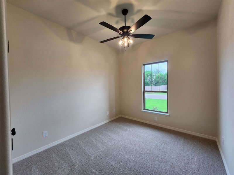 Interior room featuring a vaulted ceiling with a modern ceiling fan and lighting fixture