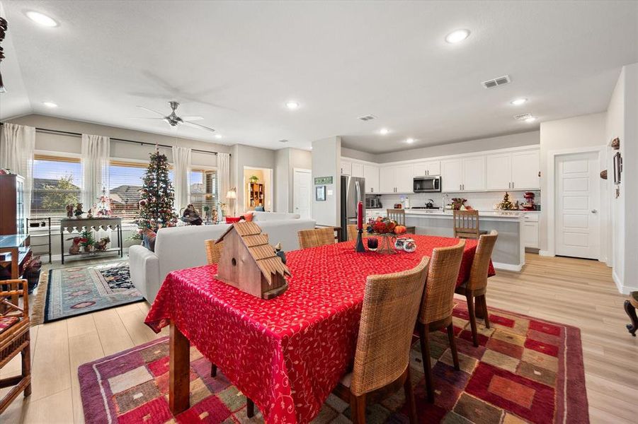 Dining room featuring light wood finished floors, a ceiling fan, and recessed lighting Dining room featuring light wood finished floors, a ceiling fan, and recessed lighting
