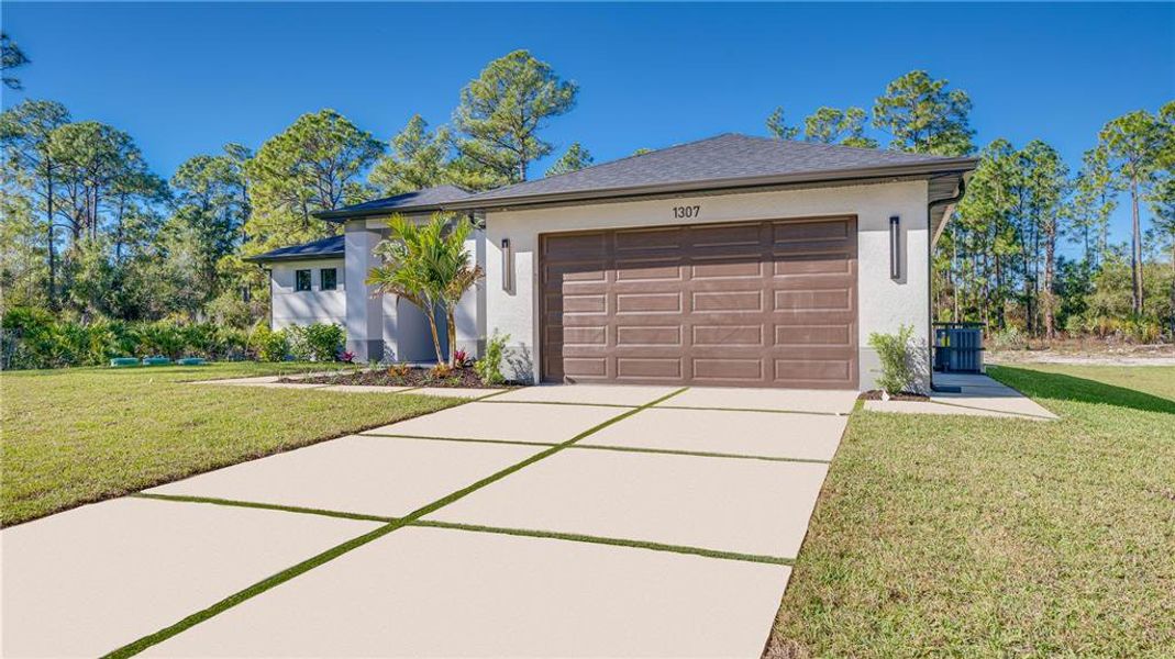 Front exterior of a new home in , Lehigh Acres, FL, highlighting curb appeal (Image 2). Front exterior of a new home in , Lehigh Acres, FL, highlighting curb appeal (Image 2).