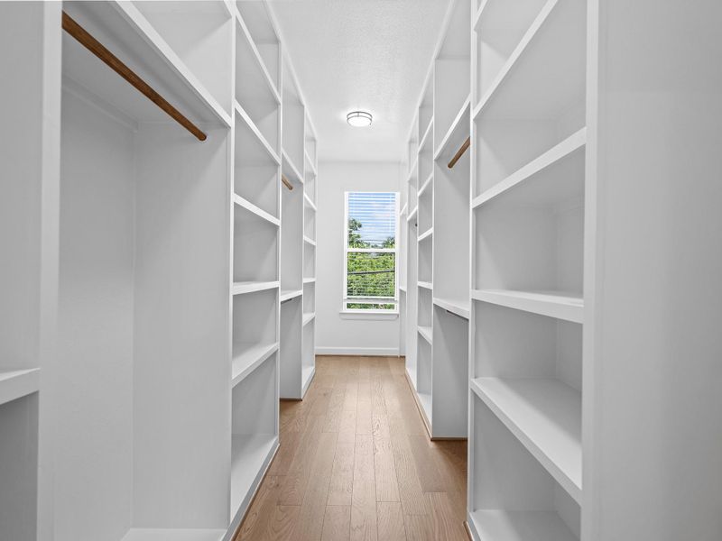 Step into a deeply designed primary closet offering exceptional storage space, smart organization, and room to spare—perfect for keeping your wardrobe effortless and clutter-free. Image depicts home as-is.