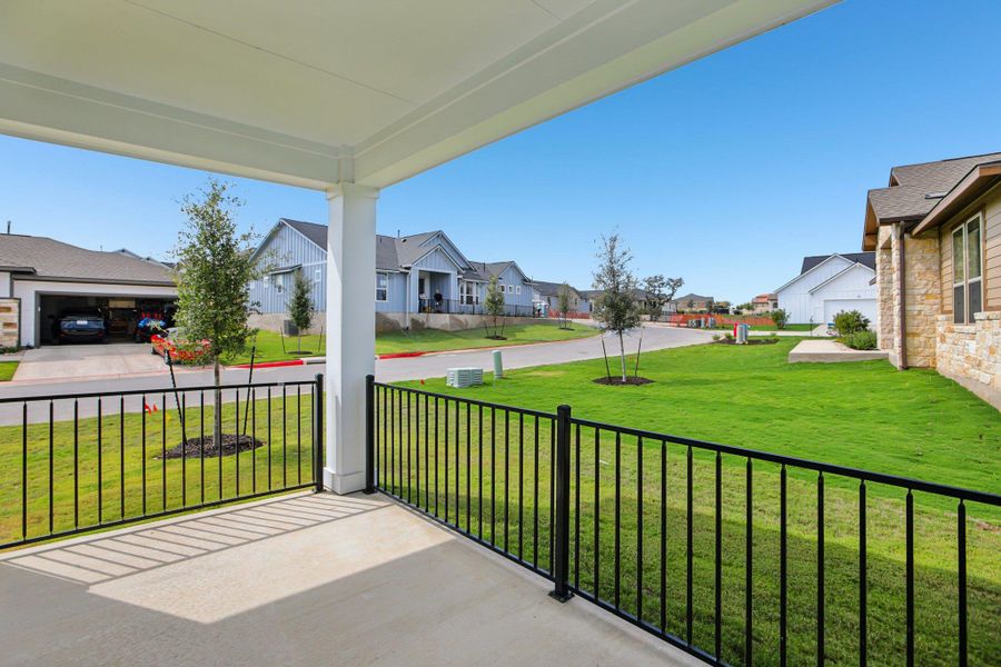 Covered porch with a lawn and a residential view Covered porch with a lawn and a residential view