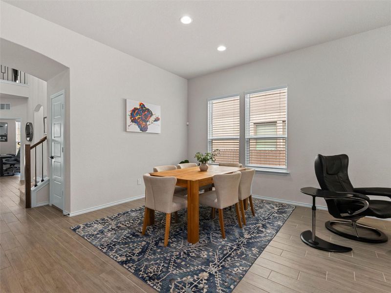 Dining space with wood tiled finished floors and recessed lighting