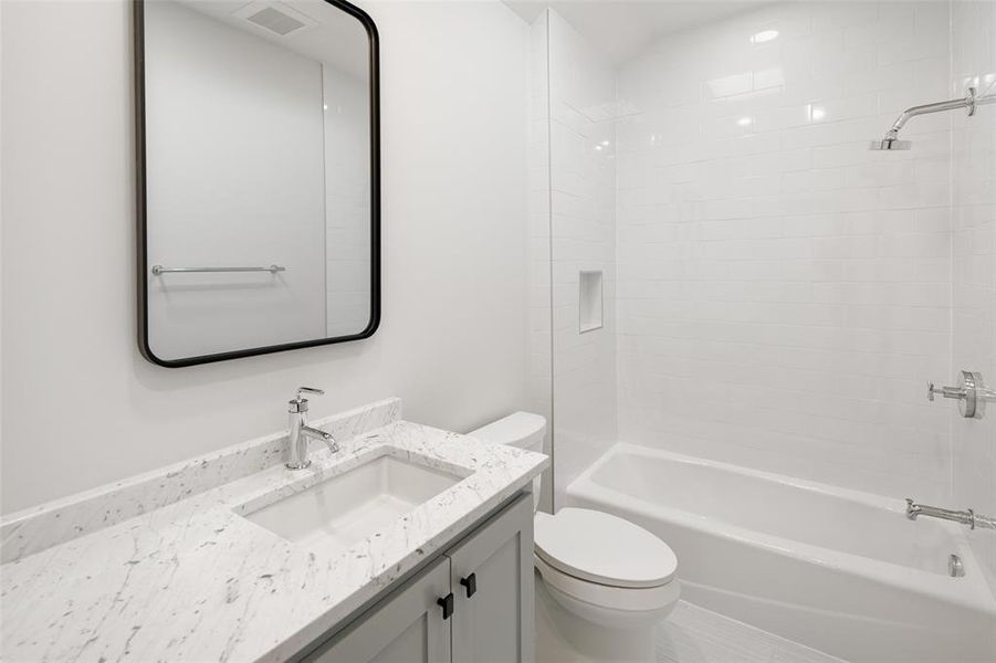 Full bathroom with shower / tub combination, vanity, and toilet