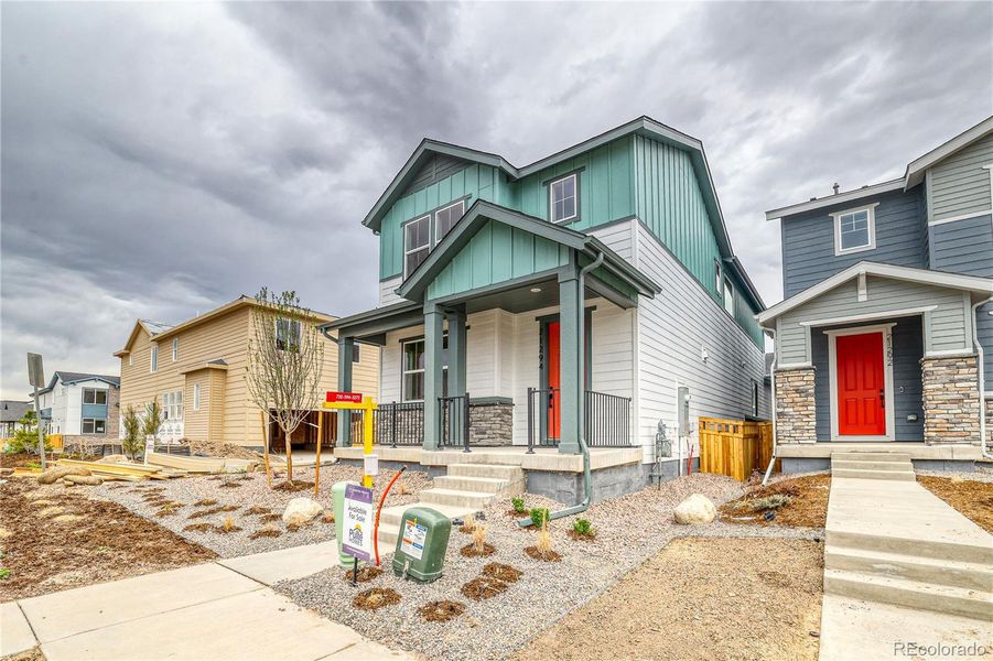 Front exterior of a new home in Painted Prairie, Aurora, CO, highlighting curb appeal (Image 18).