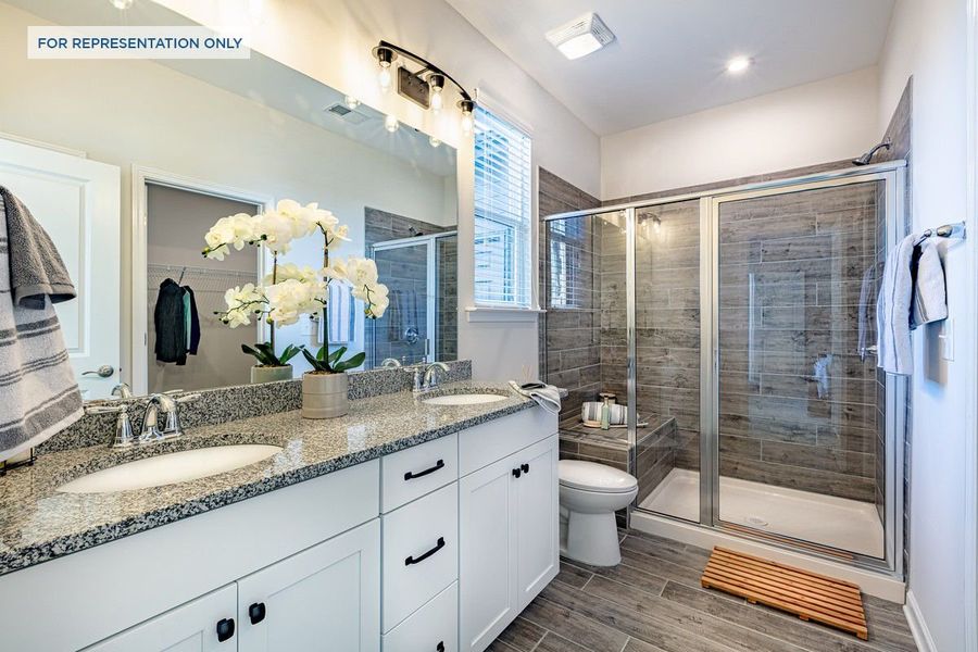 Owner's Suite Bathroom with dual vanities and walk-in shower.