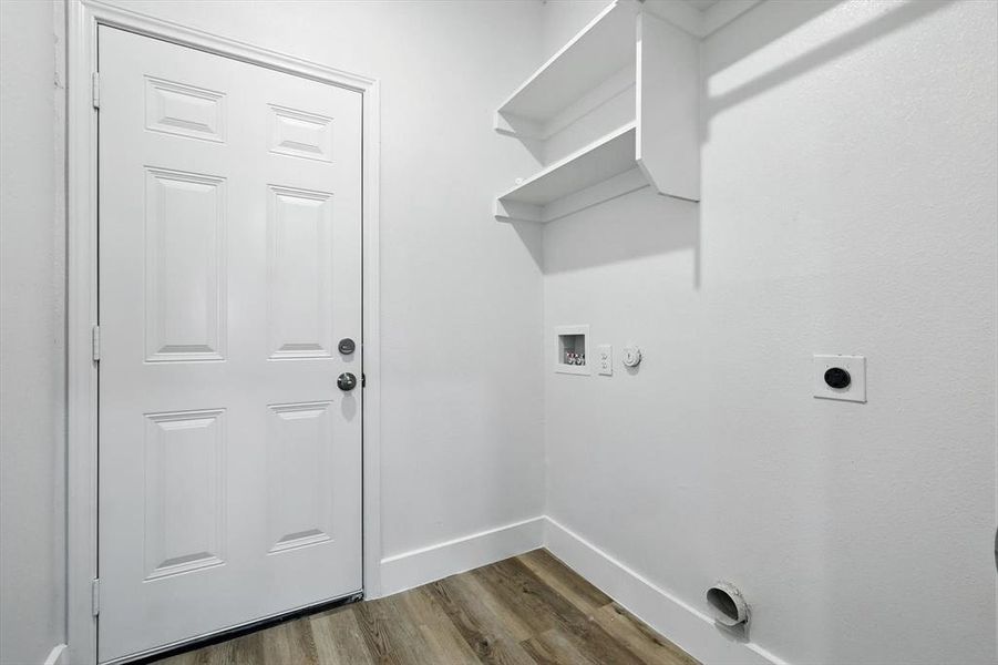 Laundry room featuring hookup for a gas dryer, dark wood finished floors, hookup for an electric dryer, and hookup for a washing machine Laundry room featuring hookup for a gas dryer, dark wood finished floors, hookup for an electric dryer, and hookup for a washing machine