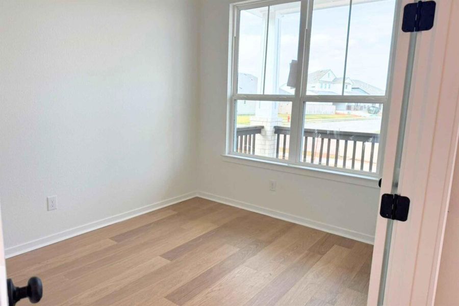 Unfurnished room featuring plenty of natural light and light wood-style flooring