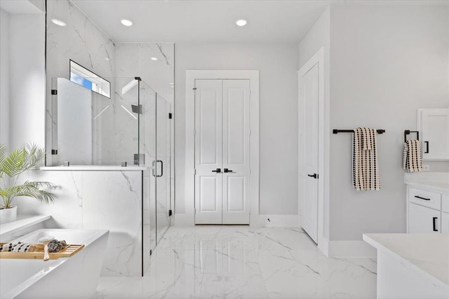 Bathroom with vanity and separate shower and tub