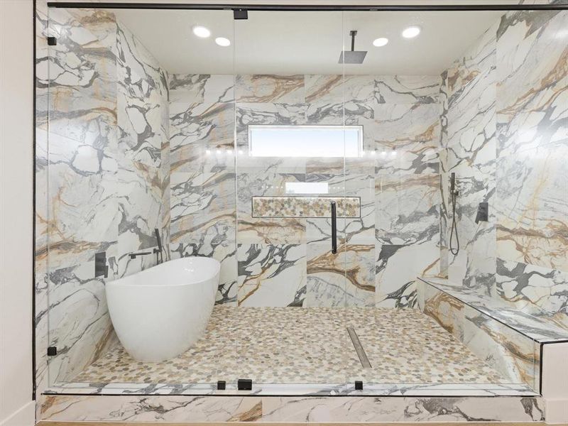 Full bathroom featuring a marble finish shower, stone wall, recessed lighting, and a freestanding bath