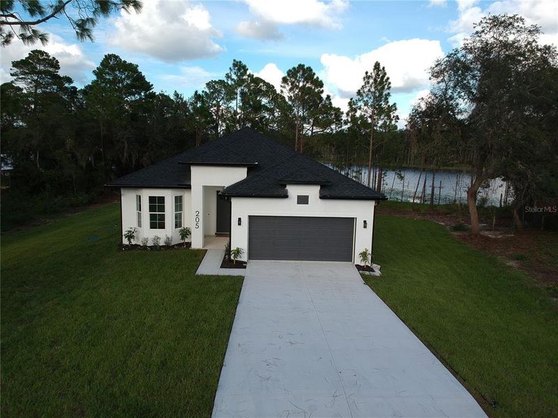 Front exterior of a new home in , Deltona, FL, highlighting curb appeal (Image 24). Front exterior of a new home in , Deltona, FL, highlighting curb appeal (Image 24).