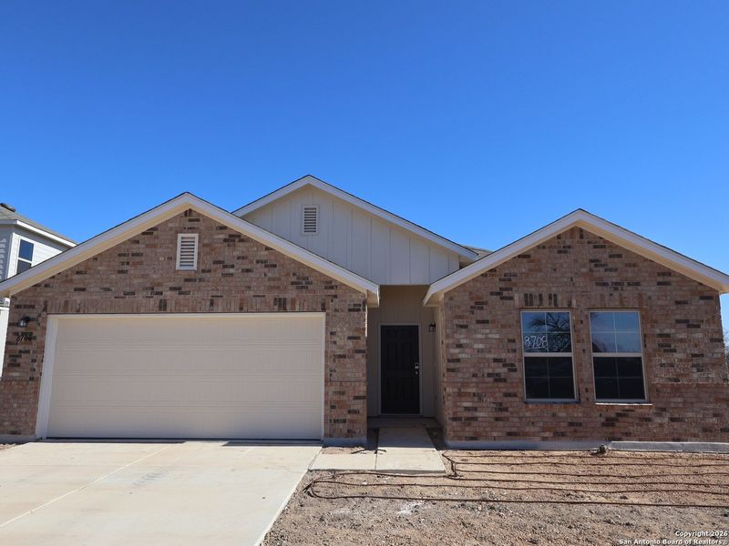 Front exterior of a new home in Greenspoint Heights, Seguin, TX, highlighting curb appeal (Image 21).