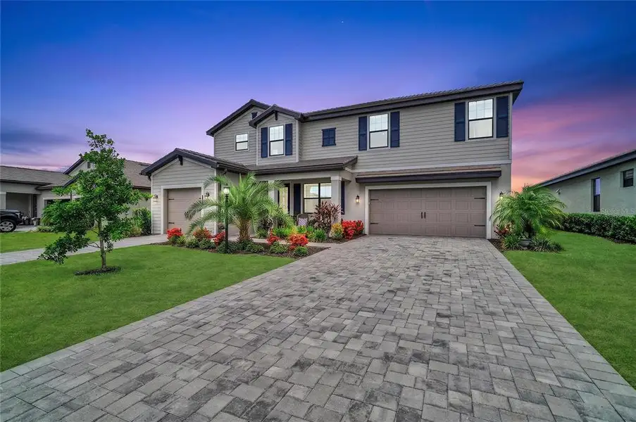 Front exterior of a new home in , Lakewood Ranch, FL, highlighting curb appeal (Image 24).