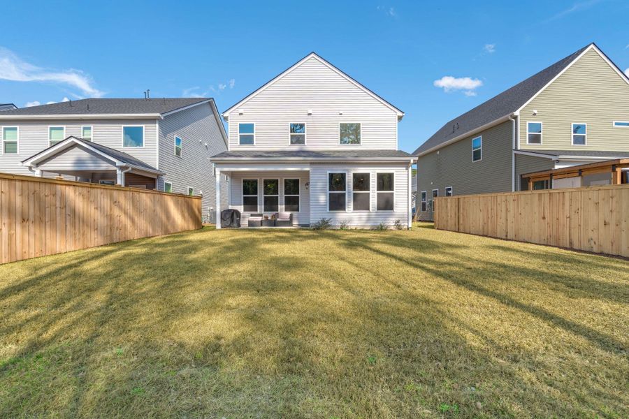 Exterior details and patio area of a home in Jasmine Point at Lakes of Cane Bay, Summerville (Image 25).