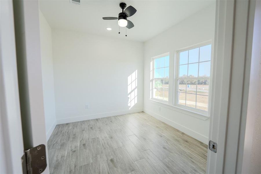 Spare room with light wood-type flooring, ceiling fan, and recessed lighting Spare room with light wood-type flooring, ceiling fan, and recessed lighting