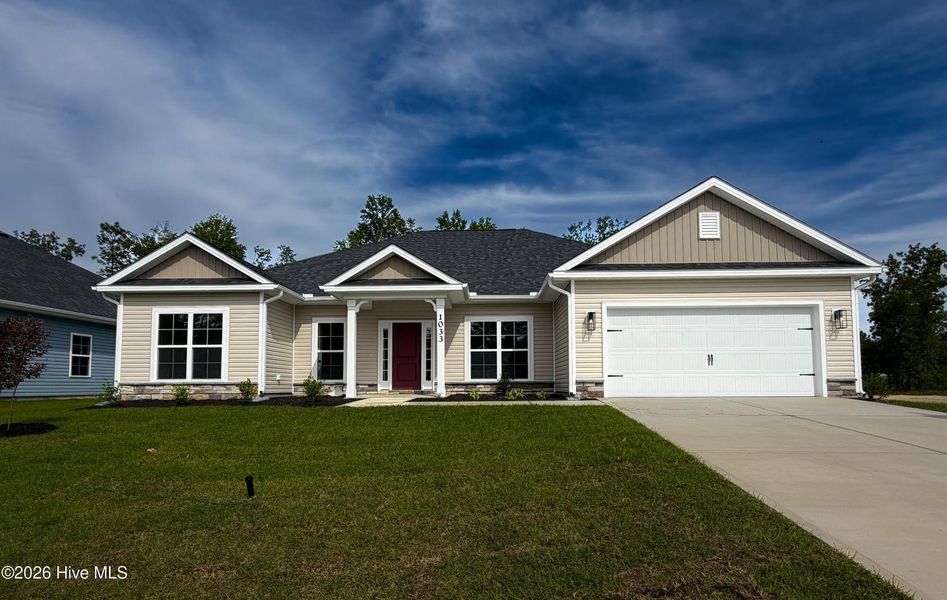 Front exterior of a new home in Wood Creek Landing, Leland, NC, highlighting curb appeal (Image 1). Front exterior of a new home in Wood Creek Landing, Leland, NC, highlighting curb appeal (Image 1).