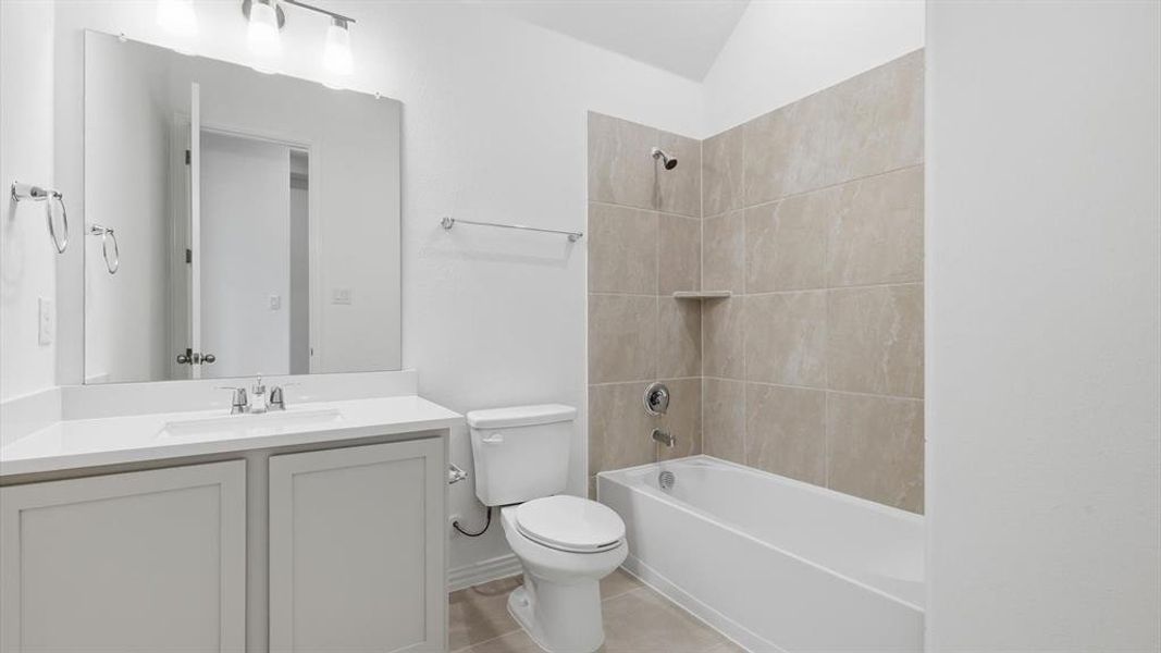 Bathroom featuring a single vanity with light grey cabinetry, white countertop, and an undermount sink Bathroom featuring a single vanity with light grey cabinetry, white countertop, and an undermount sink