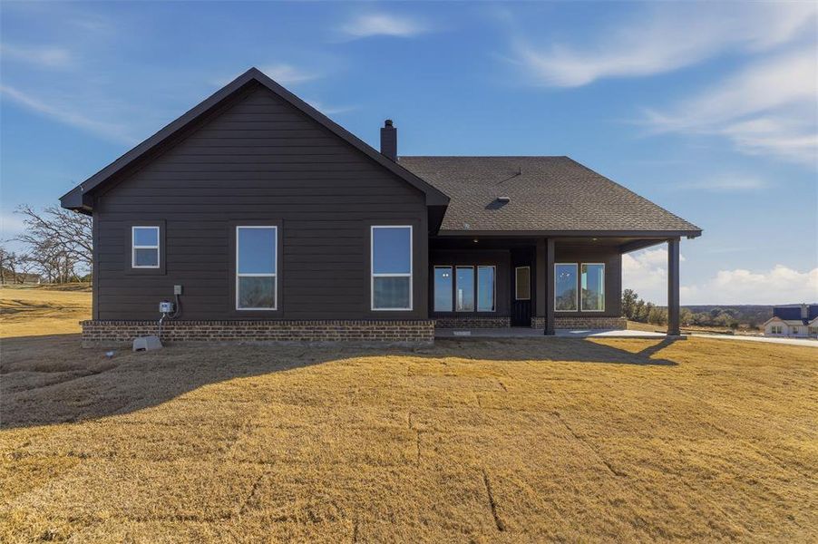 Exterior details and patio area of a home in Oak Grove Addition, Springtown (Image 22).