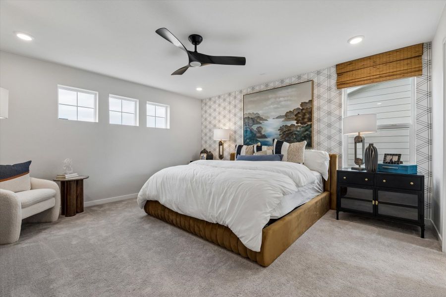 A bedroom with a bed and a chair. A bedroom with a bed and a chair.