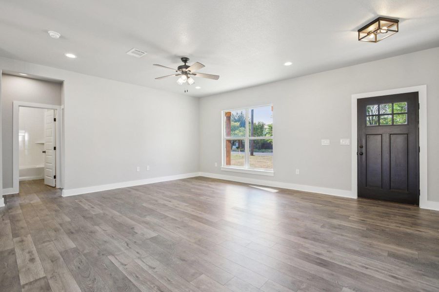 Unfurnished living room featuring light wood-type flooring, recessed lighting, and a ceiling fan