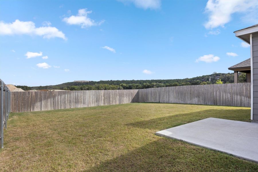 Fenced backyard with a patio