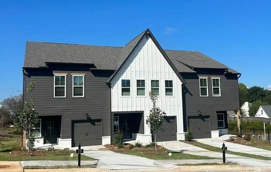 Front exterior of a new home in Downtown Fausett, Dawsonville, GA, highlighting curb appeal (Image 1). Front exterior of a new home in Downtown Fausett, Dawsonville, GA, highlighting curb appeal (Image 1).