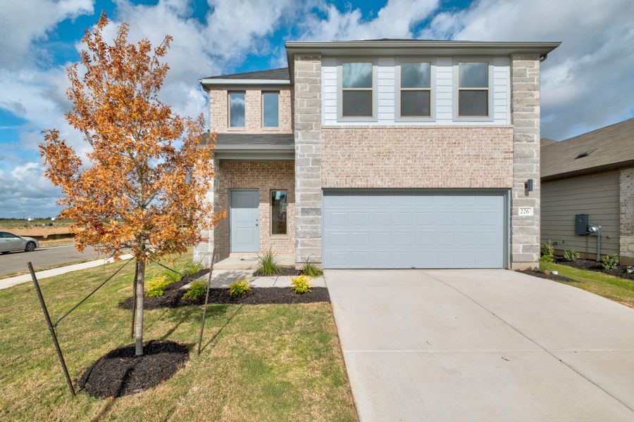 Front exterior of a new home in Trinity Ranch, Elgin, TX, highlighting curb appeal (Image 1). Front exterior of a new home in Trinity Ranch, Elgin, TX, highlighting curb appeal (Image 1).