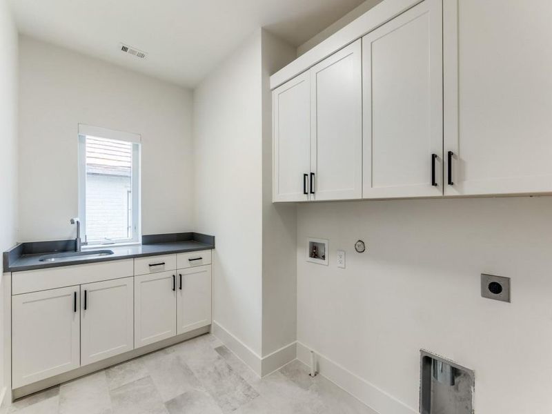 Large Laundry Room with sink and folding area w lots of cabinets!