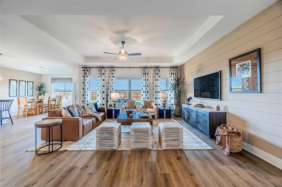 Living room featuring ceiling fan, hardwood / wood-style flooring, and a wealth of natural light